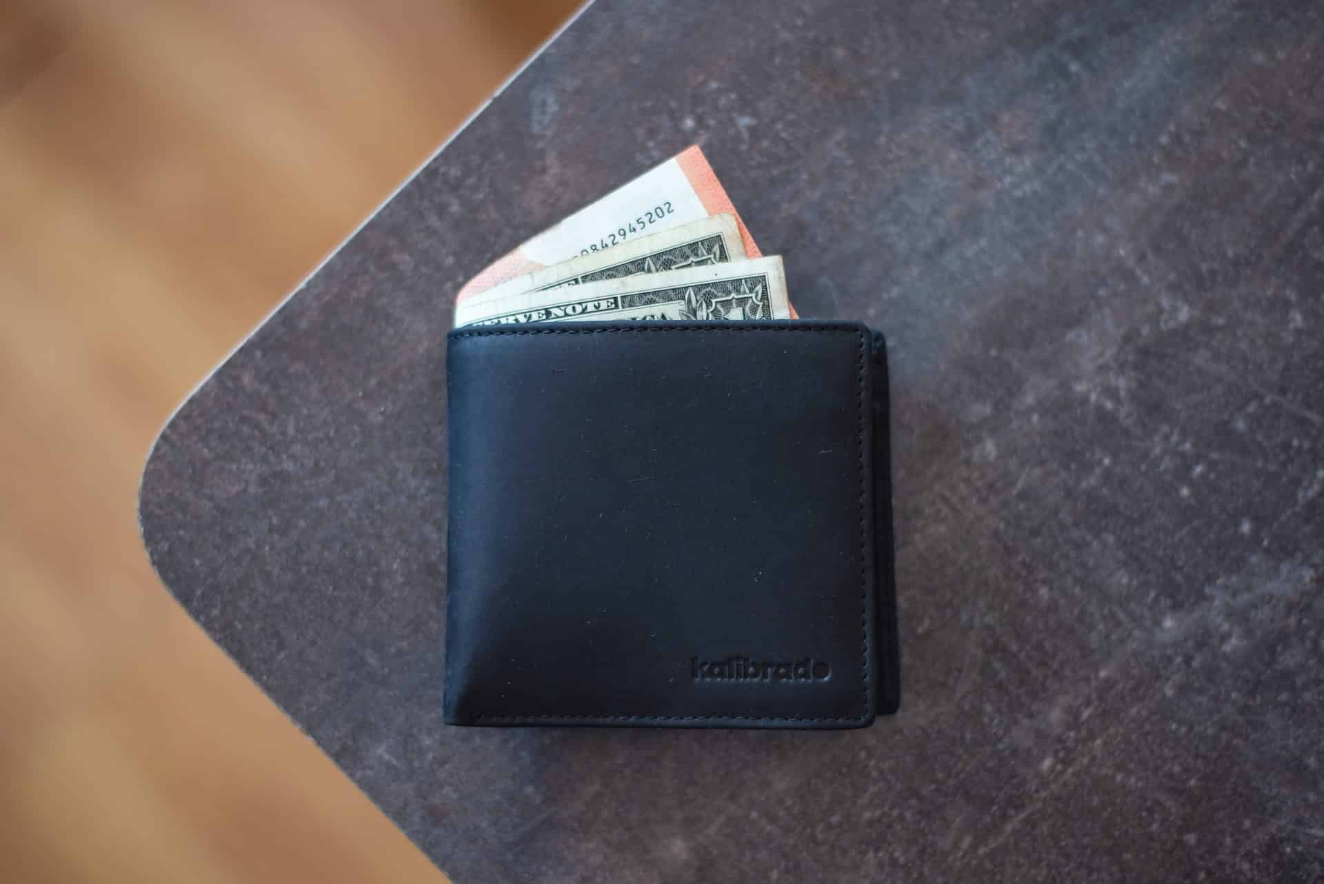 Wallet with cash sticking out, symbolizing AWS billing costs